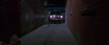 Movie still from “Go” (1999), directed by Doug Liman – A truck parked in an alleyway at night; Wide shot, Low angle