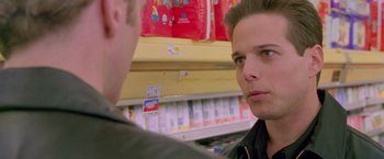 Movie still from “Go” (1999), directed by Doug Liman – A man is talking to another man in a store; Close Up shot, Low angle