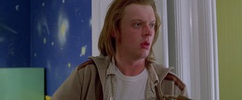 Movie still from “Go” (1999), directed by Doug Liman – A man with long blonde hair is looking at the camera; Close Up shot, Low angle