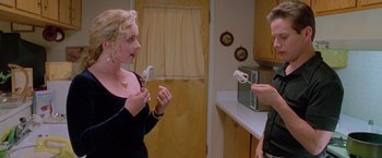 Movie still from “Go” (1999), directed by Doug Liman – Two women in a kitchen one is holding a fork and the other is holding a spoon; Close Up shot, High angle