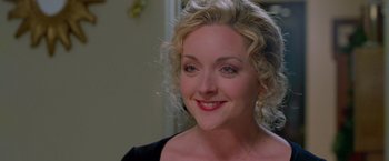 Movie still from “Go” (1999), directed by Doug Liman – A person with curly hair smiling; Close Up shot, Over the shoulder angle