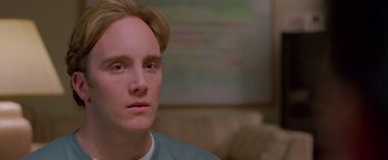 Movie still from “Go” (1999), directed by Doug Liman – A person looking at the camera; Close Up shot, Low angle