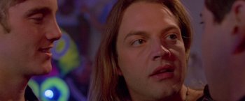 Movie still from “Go” (1999), directed by Doug Liman – A person with long hair; Close Up shot, Low angle