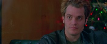 Movie still from “Go” (1999), directed by Doug Liman – A person wearing a green shirt; Close Up shot, Low angle