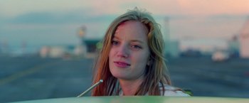 Movie still from “Go” (1999), directed by Doug Liman – A person with long red hair; Close Up shot, Low angle