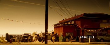 Movie still from “Goal! The Dream Begins” (2005), directed by Michael Winterbottom – A group of people standing on the side of a road; Extreme Wide shot, Low angle