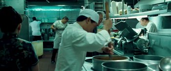 Movie still from “Goal! The Dream Begins” (2005), directed by Michael Winterbottom – A group of chefs in a kitchen preparing food; Medium shot, High angle