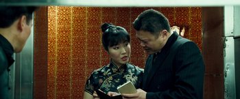 Movie still from “Goal! The Dream Begins” (2005), directed by Michael Winterbottom – A man and a woman are looking at a book together; Close Up shot, Over the shoulder angle