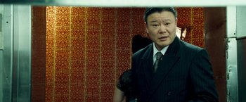 Movie still from “Goal! The Dream Begins” (2005), directed by Michael Winterbottom – A man standing in front of a mirror in front of a wall; Medium shot, Low angle