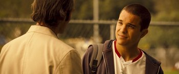 Movie still from “Goal! The Dream Begins” (2005), directed by Michael Winterbottom – Two young men talking to each other in a park; Close Up shot, Over the shoulder angle