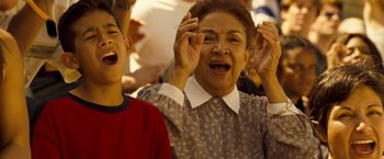 Movie still from “Goal! The Dream Begins” (2005), directed by Michael Winterbottom – An older woman and a young boy are laughing together; Close Up shot, Low angle