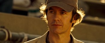 Movie still from “Goal! The Dream Begins” (2005), directed by Michael Winterbottom – A person wearing a hat; Close Up shot, Over the shoulder angle