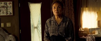 Movie still from “Goal! The Dream Begins” (2005), directed by Michael Winterbottom – An older woman standing in front of a window; Medium shot, Low angle