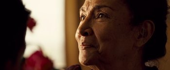 Movie still from “Goal! The Dream Begins” (2005), directed by Michael Winterbottom – An older woman looking off into the distance; Close Up shot, Low angle