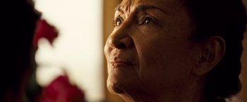 Movie still from “Goal! The Dream Begins” (2005), directed by Michael Winterbottom – An older woman looking into the distance with her eyes wide open; Extreme Close Up shot, Low angle