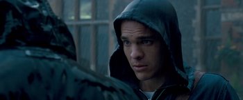Movie still from “Goal! The Dream Begins” (2005), directed by Michael Winterbottom – A young man wearing a hooded jacket looking at the camera; Close Up shot, Over the shoulder angle