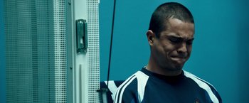 Movie still from “Goal! The Dream Begins” (2005), directed by Michael Winterbottom – A person in a room near a wall; Close Up shot, Low angle