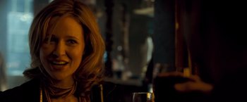 Movie still from “Goal! The Dream Begins” (2005), directed by Michael Winterbottom – A person sitting at a table with a glass; Close Up shot, Over the shoulder angle