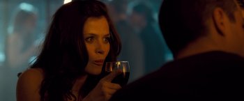 Movie still from “Goal! The Dream Begins” (2005), directed by Michael Winterbottom – A woman holding a glass of red wine in her right hand; Close Up shot, Over the shoulder angle