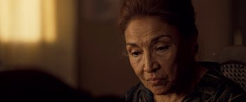 Movie still from “Goal! The Dream Begins” (2005), directed by Michael Winterbottom – An older woman looking sad while sitting in a chair; Close Up shot, Low angle