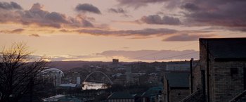 Movie still from “Goal! The Dream Begins” (2005), directed by Michael Winterbottom – A view of a city skyline at sunset; Extreme Wide shot, High angle