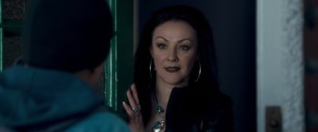 Movie still from “Goal! The Dream Begins” (2005), directed by Michael Winterbottom – A woman in a leather jacket looking into a mirror; Close Up shot, Over the shoulder angle