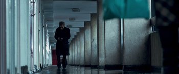 Movie still from “Goal! The Dream Begins” (2005), directed by Michael Winterbottom – A man is walking down a hallway with a cell phone in his hand; Wide shot, Low angle