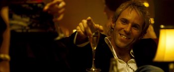 Movie still from “Goal! The Dream Begins” (2005), directed by Michael Winterbottom – A man sitting at a table holding a wine glass; Close Up shot, Low angle