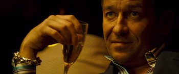 Movie still from “Goal! The Dream Begins” (2005), directed by Michael Winterbottom – A person holding a glass of wine; Close Up shot, Low angle