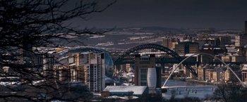 Movie still from “Goal! The Dream Begins” (2005), directed by Michael Winterbottom – A view of a city with a bridge in the middle of it; Extreme Wide shot, High angle
