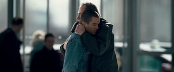 Movie still from “Goal! The Dream Begins” (2005), directed by Michael Winterbottom – Two men hugging each other in a room; Medium shot, Over the shoulder angle