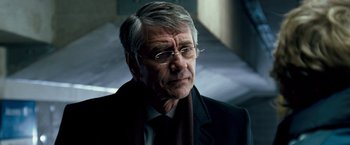 Movie still from “Goal! The Dream Begins” (2005), directed by Michael Winterbottom – An older man wearing glasses and a suit; Close Up shot, Low angle