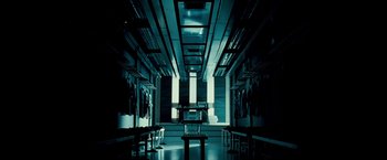 Movie still from “Goal! The Dream Begins” (2005), directed by Michael Winterbottom – A dark room with a bench in the middle of the room; Wide shot, Low angle