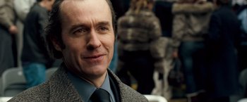 Movie still from “Goal! The Dream Begins” (2005), directed by Michael Winterbottom – A person wearing a suit and tie; Close Up shot, Over the shoulder angle