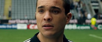 Movie still from “Goal! The Dream Begins” (2005), directed by Michael Winterbottom – A man's face as he stands on a soccer field; Close Up shot, High angle