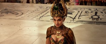 Movie still from “Gods of Egypt” (2016), directed by Alex Proyas – A woman in a costume is posing for a picture; Close Up shot, Over the shoulder angle