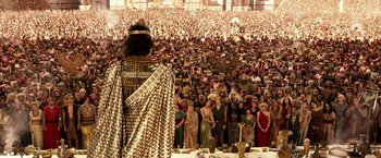 Movie still from “Gods of Egypt” (2016), directed by Alex Proyas – A large crowd of people gathered in front of a statue; Extreme Wide shot, High angle