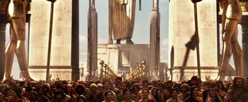 Movie still from “Gods of Egypt” (2016), directed by Alex Proyas – A crowd of people standing in front of a statue; Extreme Wide shot, Low angle