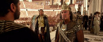 Movie still from “Gods of Egypt” (2016), directed by Alex Proyas – Two men dressed in ancient roman clothing in front of an audience; Medium shot, High angle