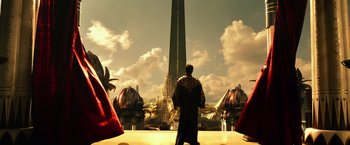 Movie still from “Gods of Egypt” (2016), directed by Alex Proyas – A man standing in front of a tall building; Extreme Wide shot, Low angle