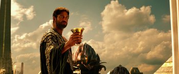 Movie still from “Gods of Egypt” (2016), directed by Alex Proyas – A man holding a glass in his hand; Medium shot, Low angle