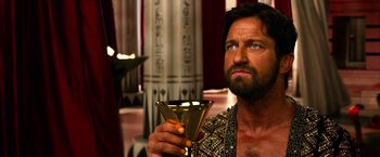 Movie still from “Gods of Egypt” (2016), directed by Alex Proyas – A man holding a glass of wine in his hand; Close Up shot, Low angle