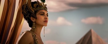 Movie still from “Gods of Egypt” (2016), directed by Alex Proyas – A woman in a gold and green headdress; Close Up shot, Low angle