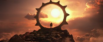 Movie still from “Gods of Egypt” (2016), directed by Alex Proyas – A man standing on top of a mountain looking at the sun; Extreme Wide shot, Low angle