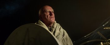 Movie still from “Gods of Egypt” (2016), directed by Alex Proyas – An older man wearing a blanket looking up at the sky; Close Up shot, Low angle