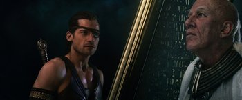 Movie still from “Gods of Egypt” (2016), directed by Alex Proyas – A person with a mirror in a dark room; Close Up shot, Over the shoulder angle
