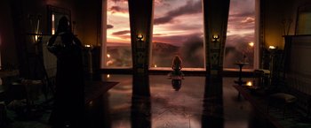 Movie still from “Gods of Egypt” (2016), directed by Alex Proyas – A woman sitting in front of a window at sunset; Extreme Wide shot, High angle