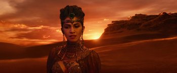 Movie still from “Gods of Egypt” (2016), directed by Alex Proyas – A woman wearing a headdress and a necklace; Close Up shot, Over the shoulder angle