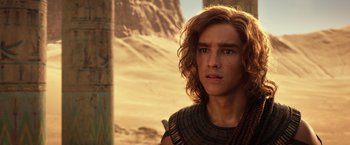 Movie still from “Gods of Egypt” (2016), directed by Alex Proyas – A man with long brown hair wearing a black shirt; Close Up shot, Over the shoulder angle