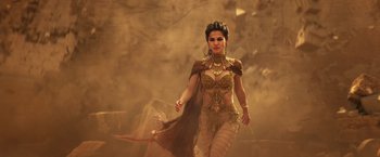 Movie still from “Gods of Egypt” (2016), directed by Alex Proyas – A woman dressed in a costume walking through the desert; Medium shot, Low angle